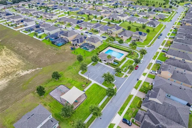 an aerial view of a house with a garden and swimming pool