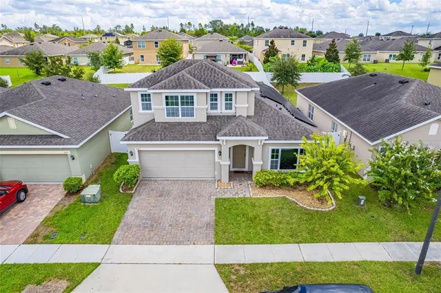 an aerial view of a house with a garden and swimming pool