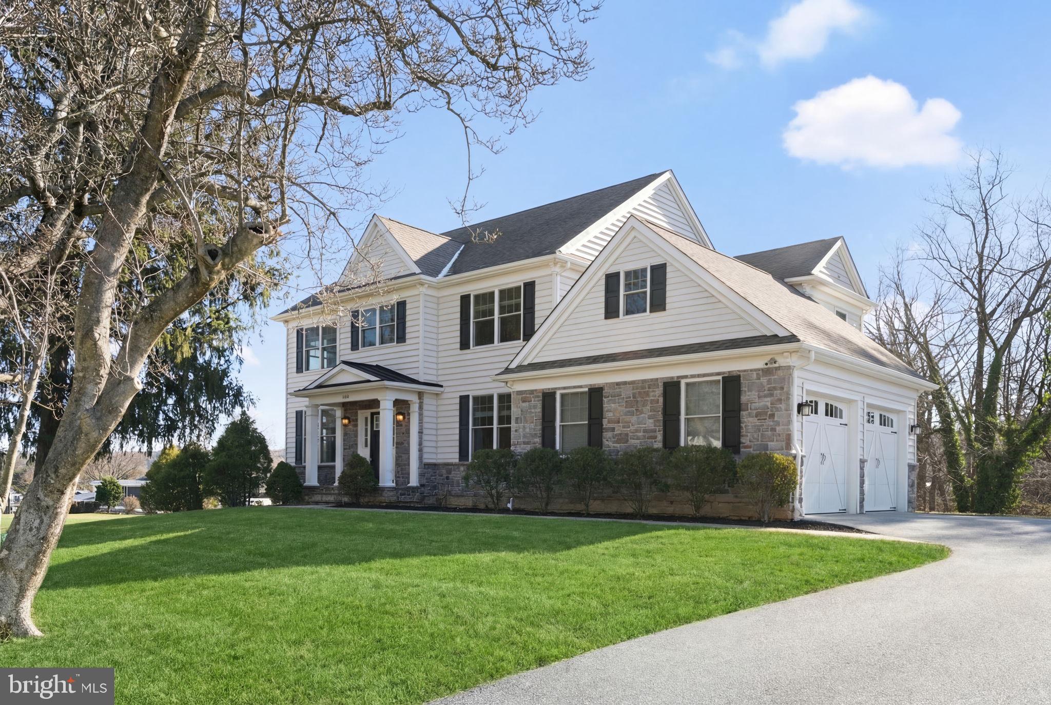 129 Conestoga Road Malvern, PA 19355 - Photo 1 of 69 a front view of a house with a garden and yard