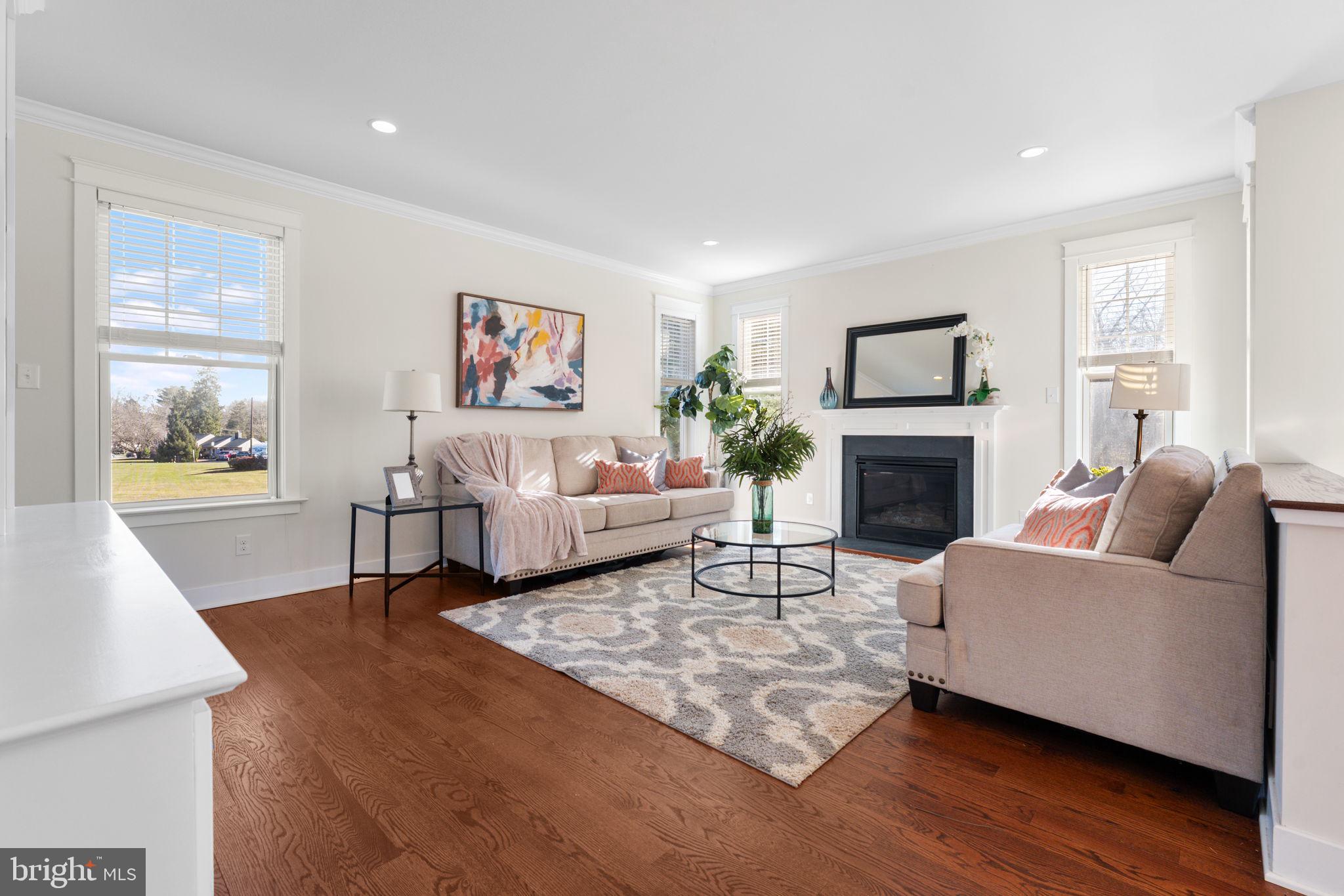 129 Conestoga Road Malvern, PA 19355 - Photo 15 of 69 a living room with furniture a fireplace and a flat screen tv