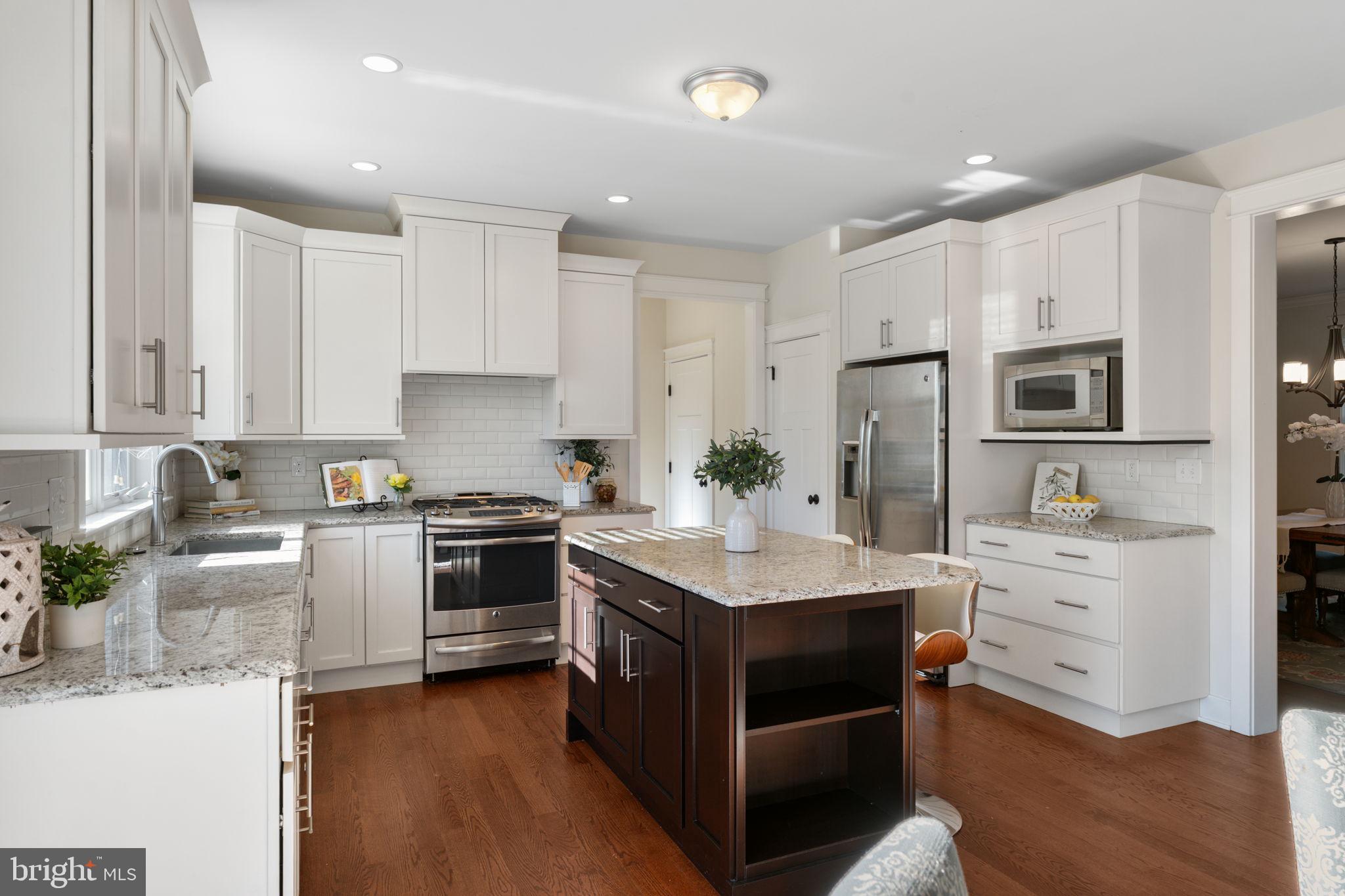 129 Conestoga Road Malvern, PA 19355 - Photo 19 of 69 a kitchen with white cabinets and stainless steel appliances