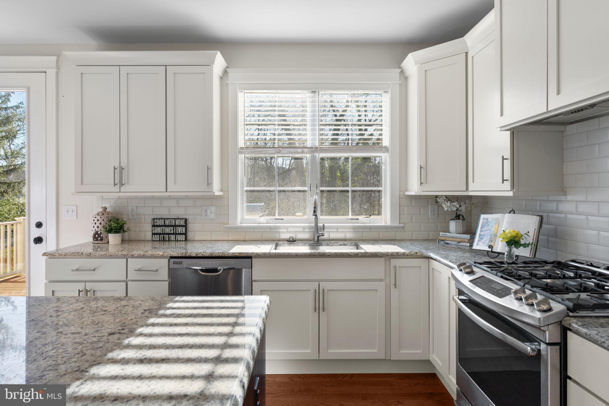 129 Conestoga Road Malvern, PA 19355 - Photo 22 of 69 a kitchen with stainless steel appliances granite countertop a stove a sink and a white cabinets