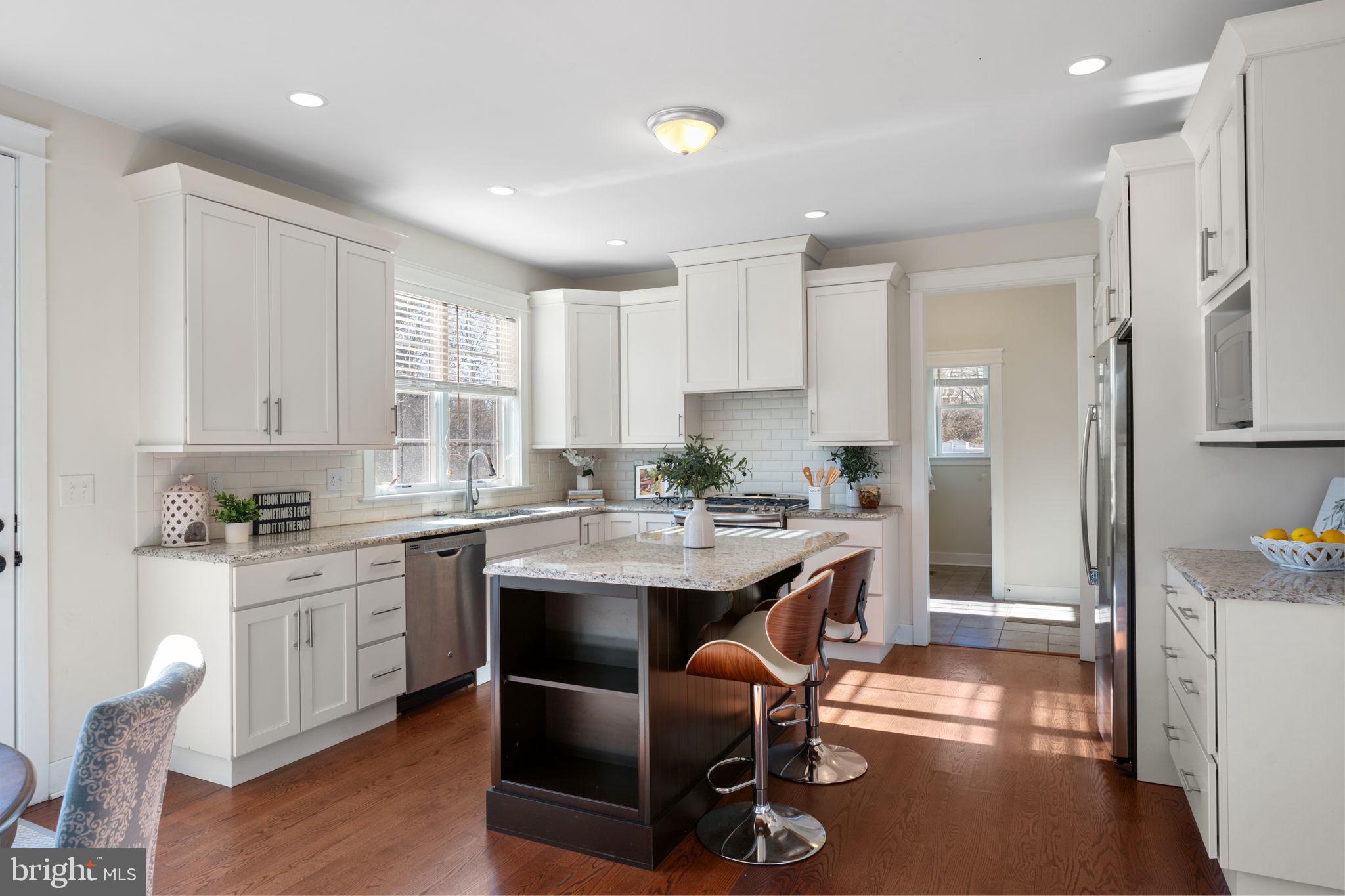 129 Conestoga Road Malvern, PA 19355 - Photo 24 of 69 a kitchen with stainless steel appliances granite countertop a table chairs sink refrigerator and cabinets