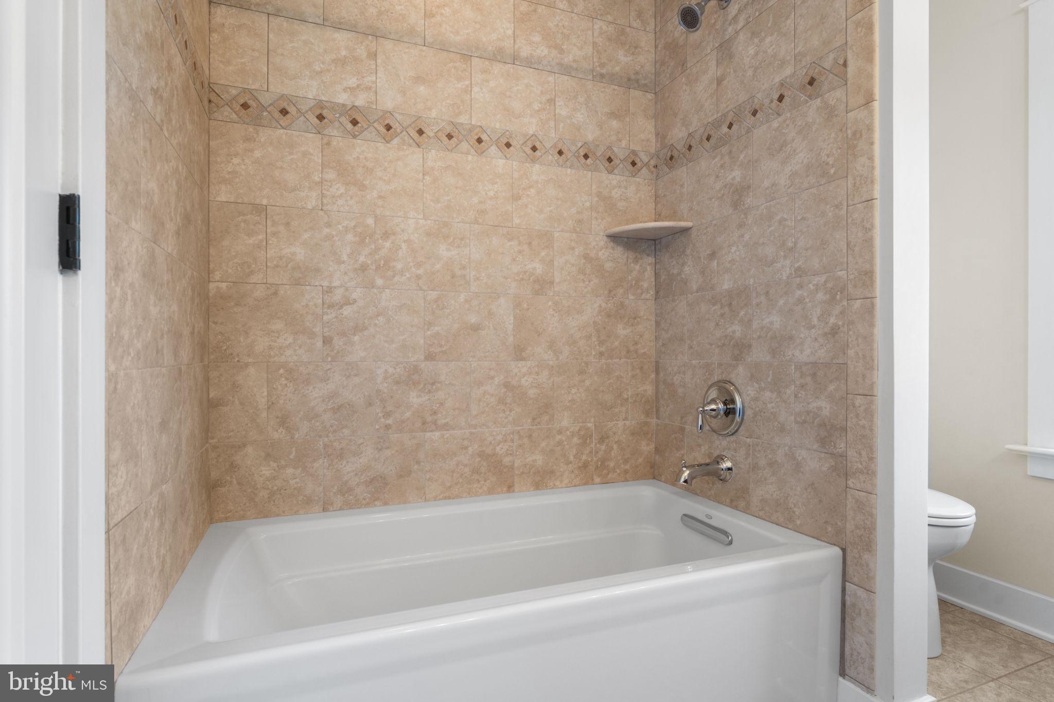 129 Conestoga Road Malvern, PA 19355 - Photo 33 of 69 a bath tub sitting next to a white toilet and a shower