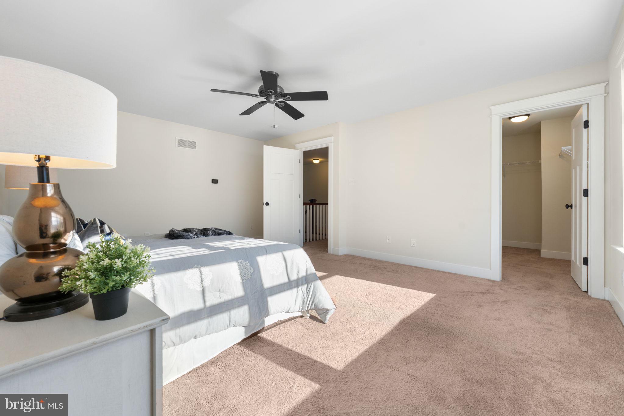 129 Conestoga Road Malvern, PA 19355 - Photo 36 of 69 a bedroom with a bed and a potted plant