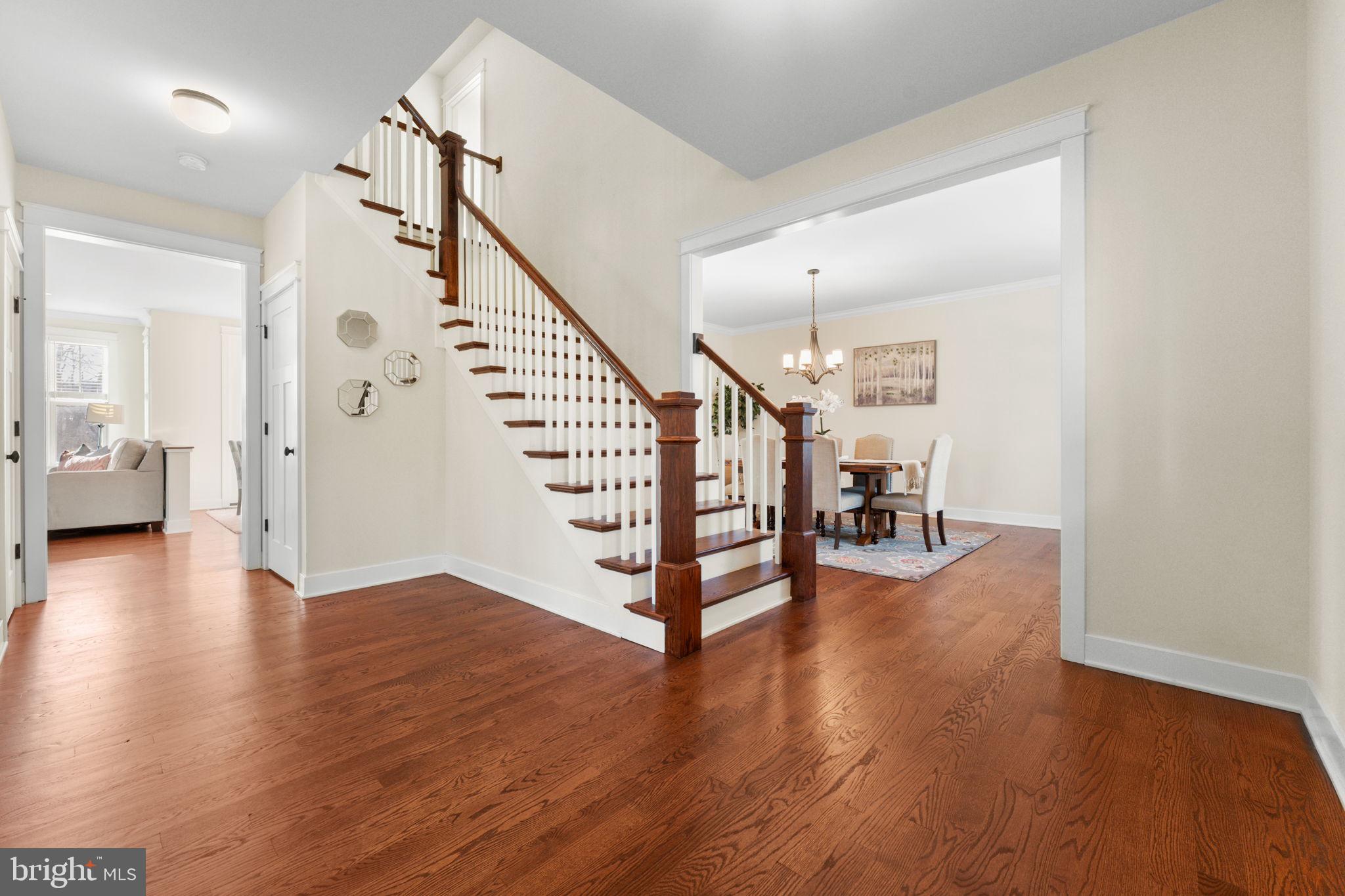 129 Conestoga Road Malvern, PA 19355 - Photo 6 of 69 a view of a hallway with wooden floor and stairs