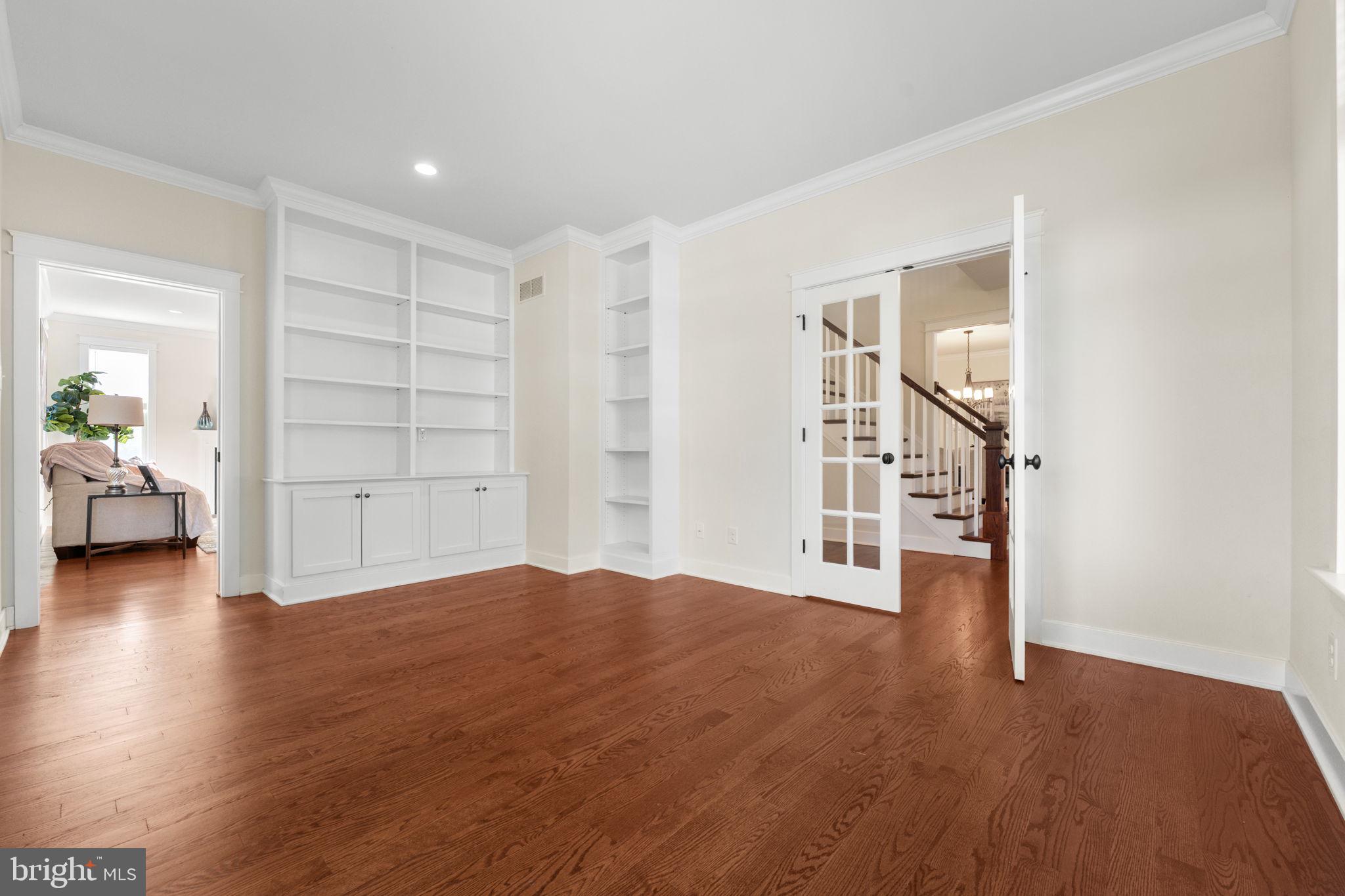 129 Conestoga Road Malvern, PA 19355 - Photo 8 of 69 a view of empty room with wooden floor and cabinet