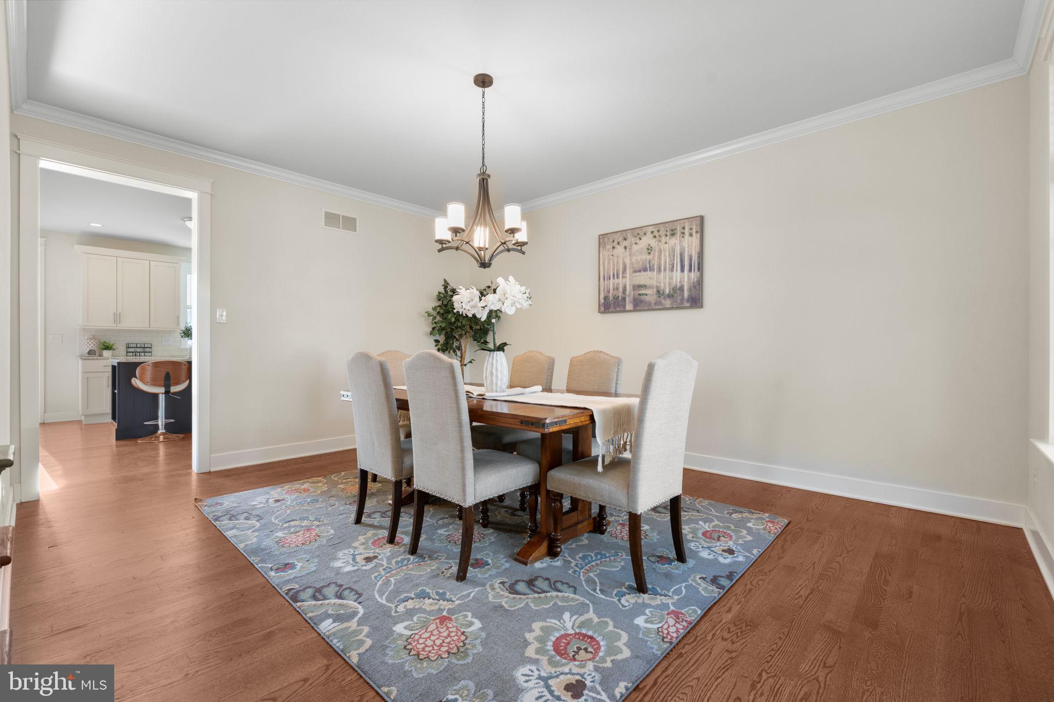 129 Conestoga Road Malvern, PA 19355 - Photo 10 of 69 a dining room with wooden floor a chandelier a wooden table and chairs