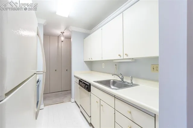 a kitchen with a sink a stove and refrigerator