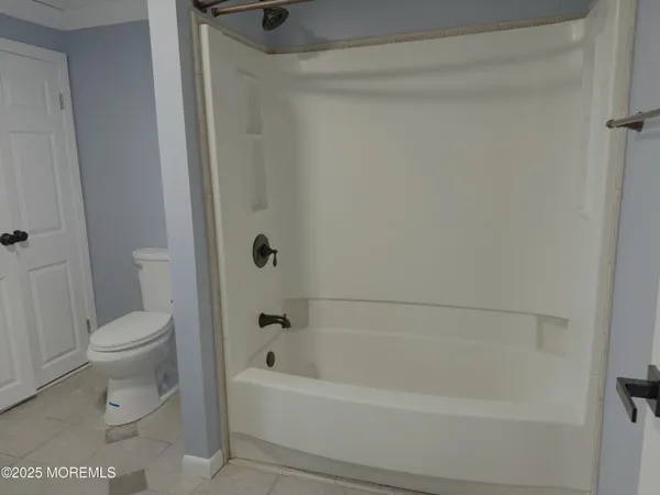 a bathroom with a toilet and bathtub