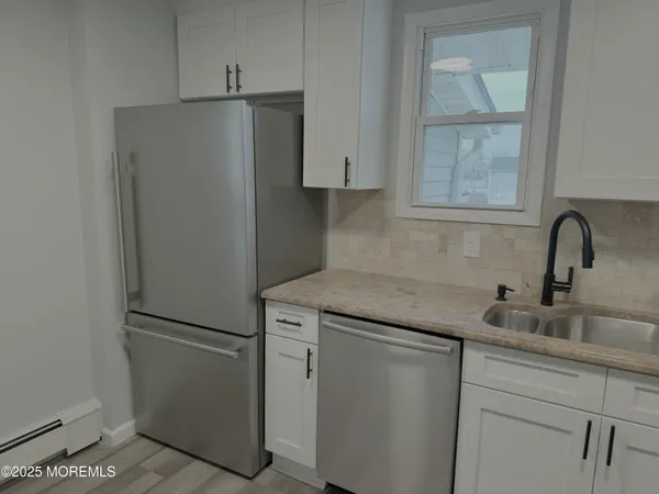 a kitchen with appliances and a sink