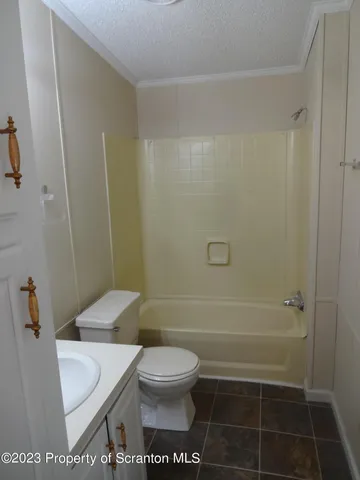 a bathroom with a toilet a sink and shower