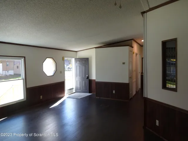 a view of a livingroom with furniture wooden floor and window