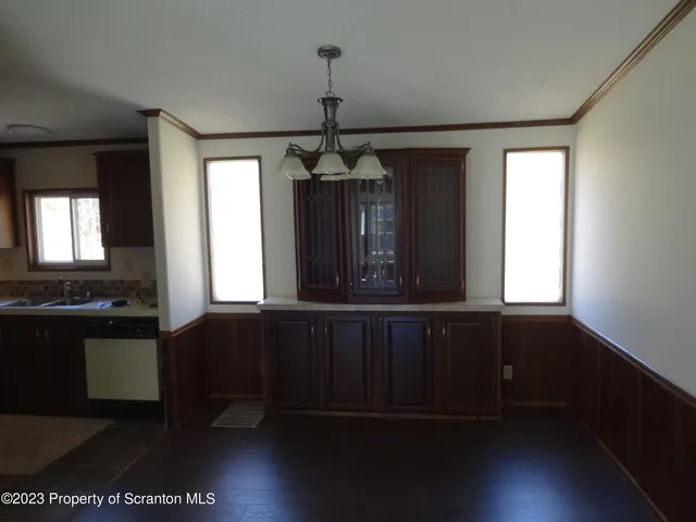 a living room with wooden floor and a window