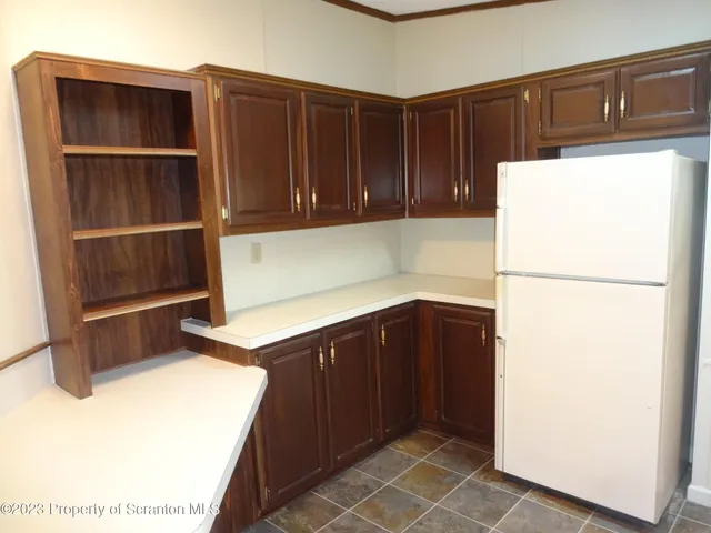 a kitchen with a refrigerator and cabinets