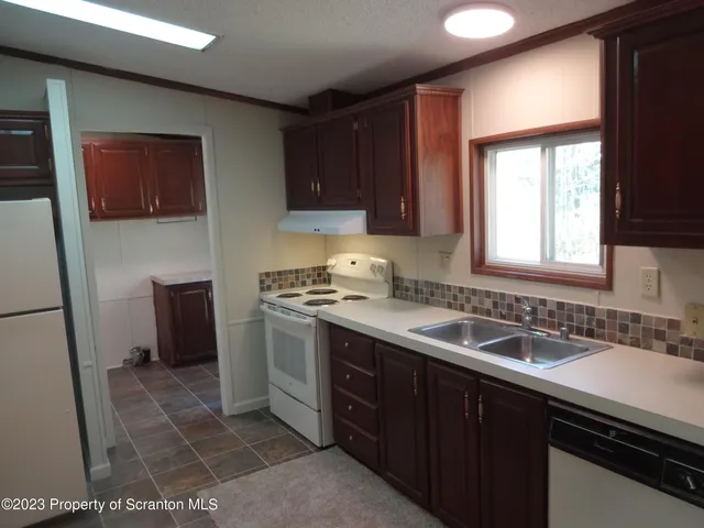 a kitchen with a sink cabinets and a window