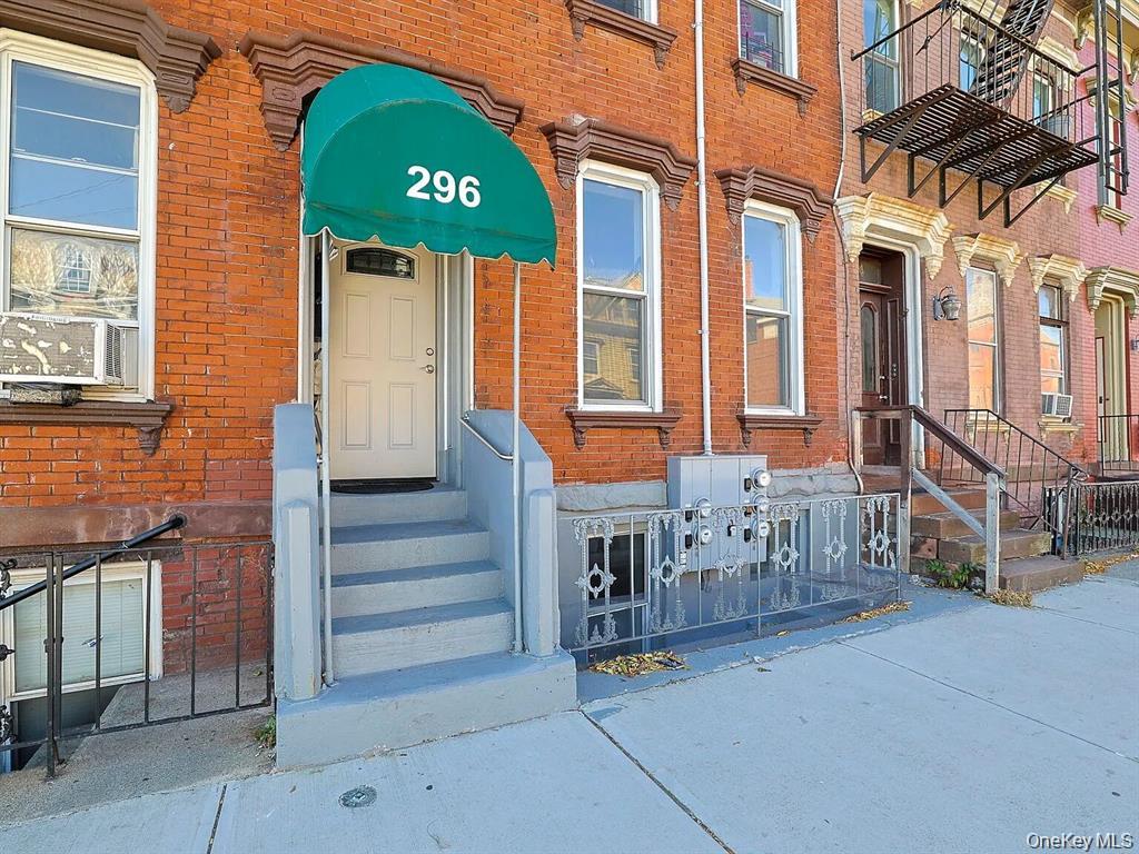 296 Mill Street, Unit 3 Poughkeepsie, NY 12601 - Photo 2 of 6 a front view of a house with a garden