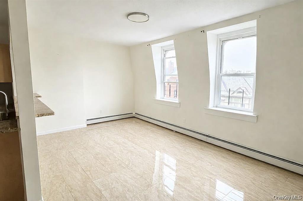 296 Mill Street, Unit 3 Poughkeepsie, NY 12601 - Photo 4 of 6 an empty room with windows