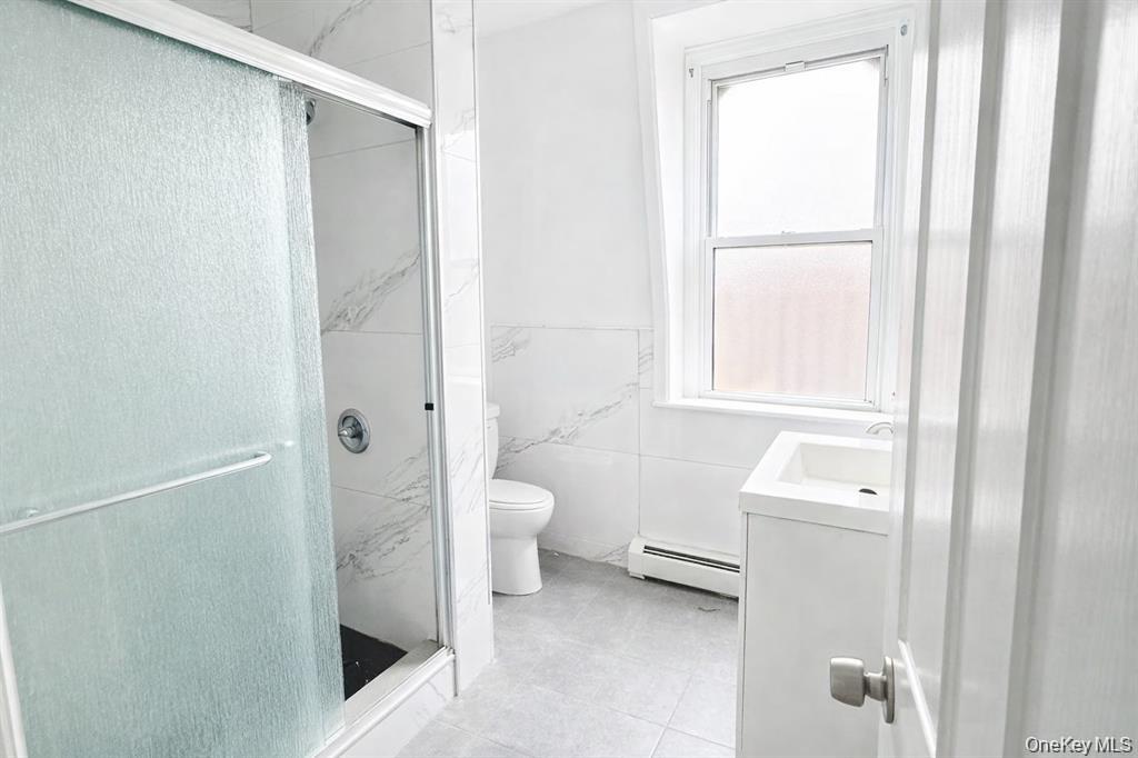 296 Mill Street, Unit 3 Poughkeepsie, NY 12601 - Photo 6 of 6 a bathroom with a toilet sink and a mirror