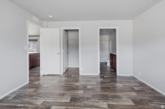 433 North 750 West Logan, UT 84321 - Photo 16 of 40 Spacious room featuring wood-finish flooring, light gray walls, white trim, and white interior doors