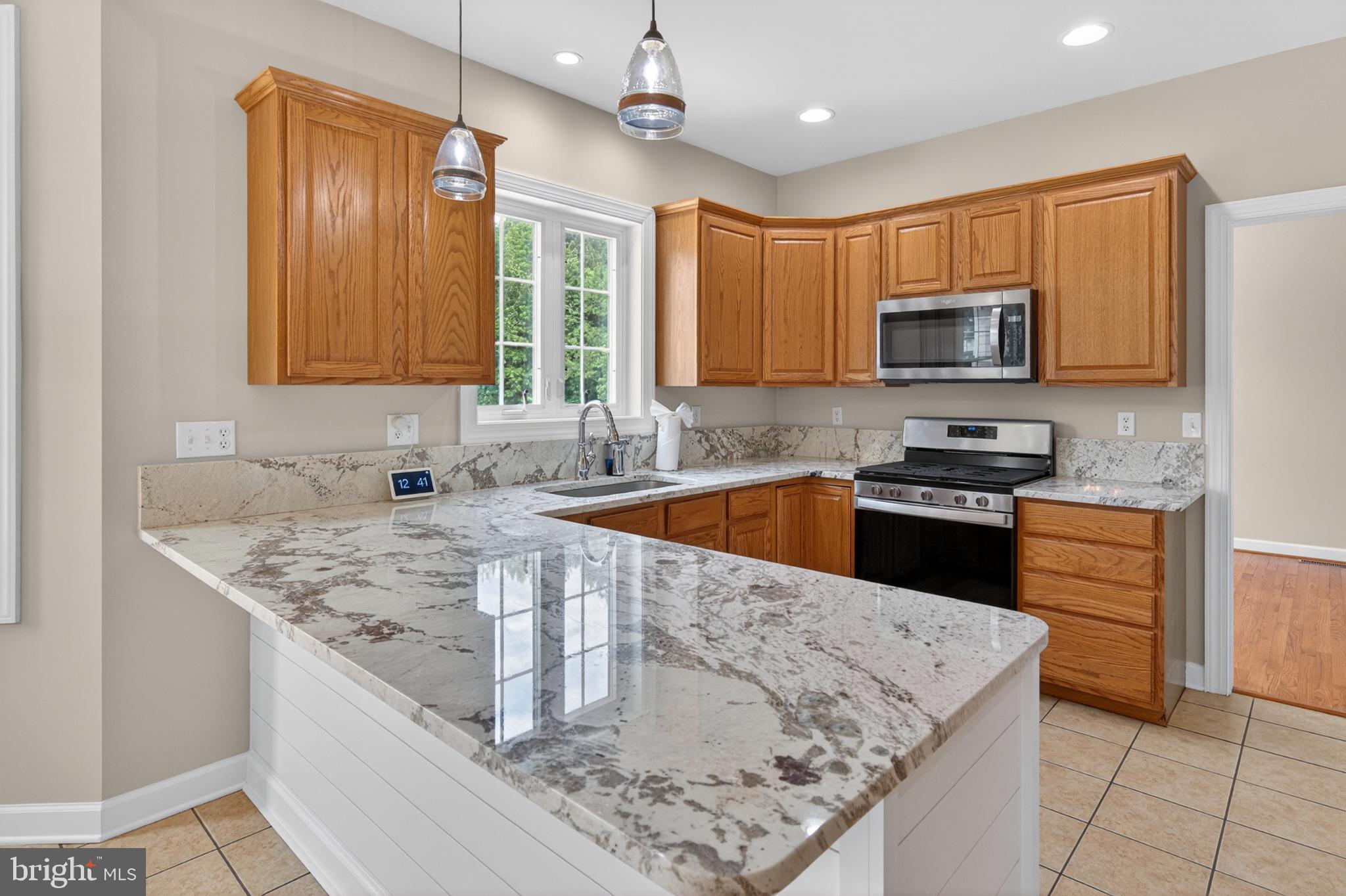 337 Roe Ingleside Road Centreville, MD 21617 - Photo 20 of 56 a kitchen with stainless steel appliances granite countertop a sink stove and refrigerator
