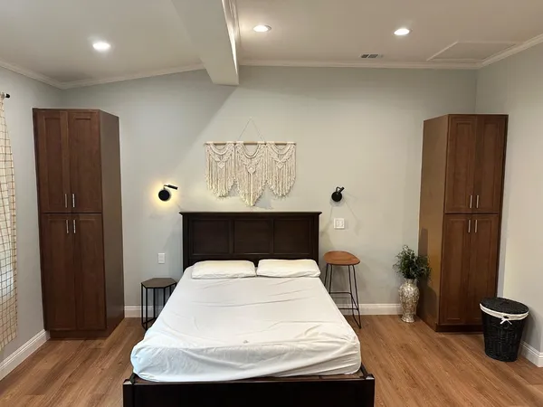 a room with a sink and wooden floor