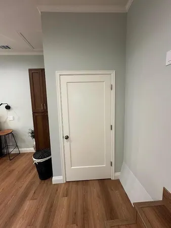 an empty room with wooden floor and closet