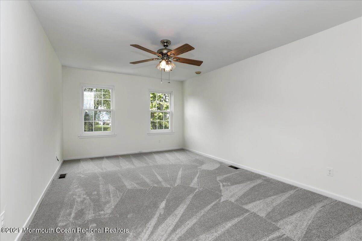 121 Walnut Drive Spring Lake Heights, NJ 07762 - Photo 20 of 44 an empty room with windows and ceiling fan