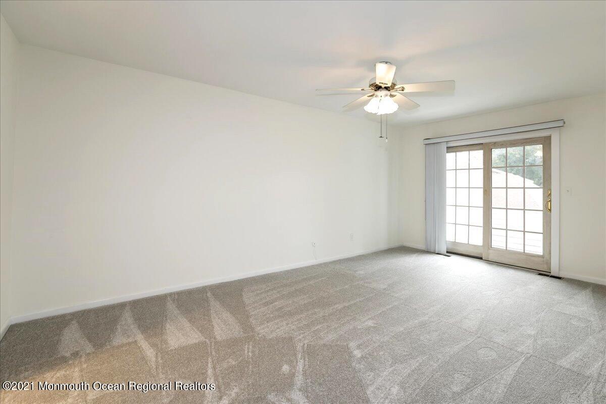 121 Walnut Drive Spring Lake Heights, NJ 07762 - Photo 23 of 44 an empty room with chandelier fan and windows