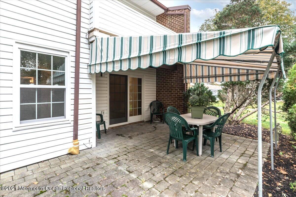 121 Walnut Drive Spring Lake Heights, NJ 07762 - Photo 30 of 44 a backyard of a house with table and chairs