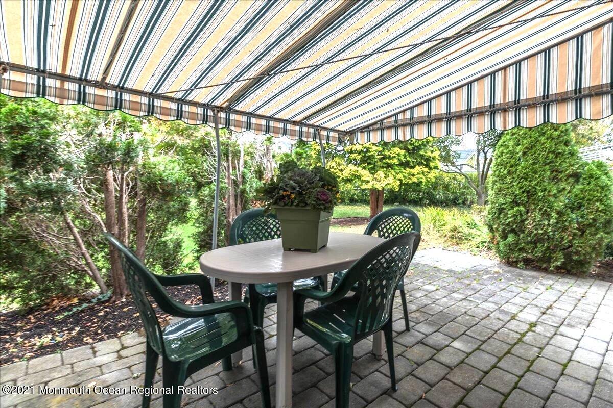 121 Walnut Drive Spring Lake Heights, NJ 07762 - Photo 32 of 44 a view of a patio with table and chairs and potted plants