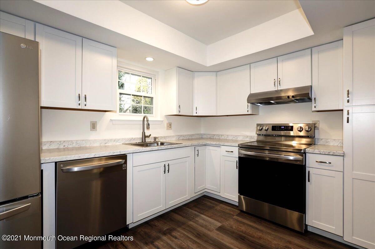121 Walnut Drive Spring Lake Heights, NJ 07762 - Photo 6 of 44 a kitchen with stainless steel appliances granite countertop a stove and white cabinets