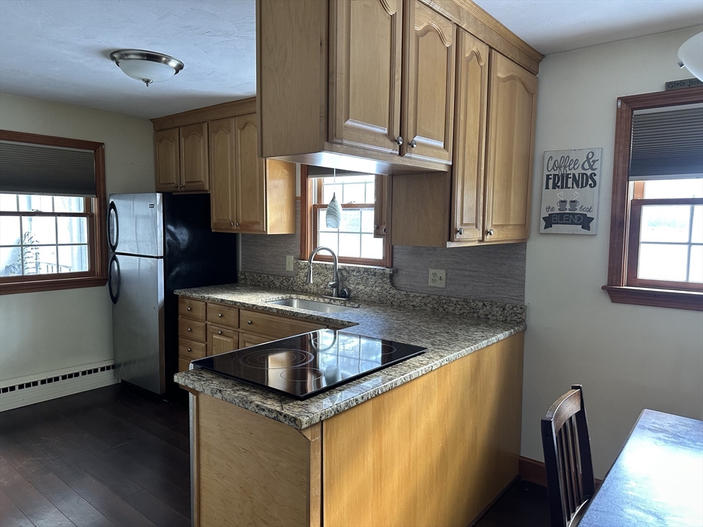 310 Palmer Road Ware, MA 01082 - Photo 2 of 16 a kitchen with stainless steel appliances granite countertop a sink a window and a refrigerator