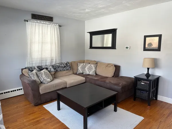 a living room with a couch and a lamp