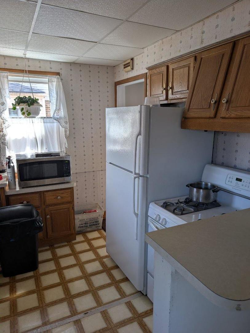 1673 Linden Street Des Plaines, IL 60018 - Photo 9 of 9 a kitchen with a refrigerator and a stove top oven