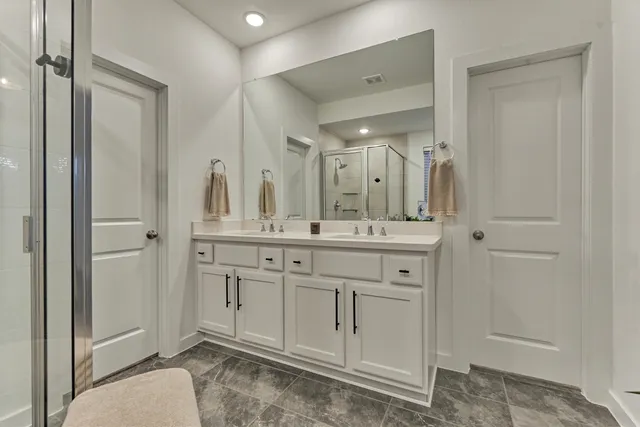 a spacious bathroom with a granite countertop sink a mirror and a