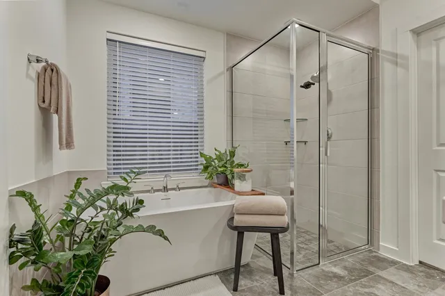 a bath room with a bathtub and a shower