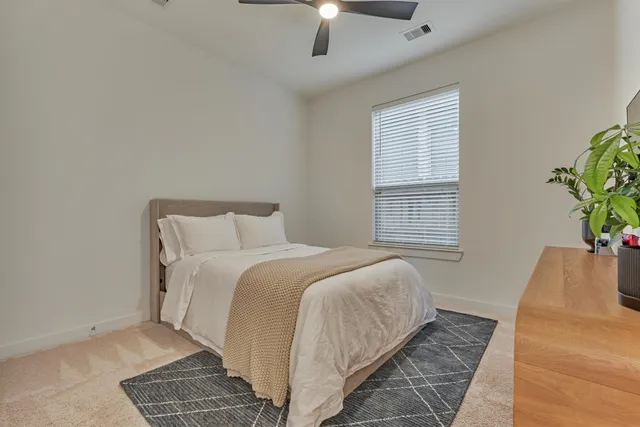 a bedroom with bed and a window