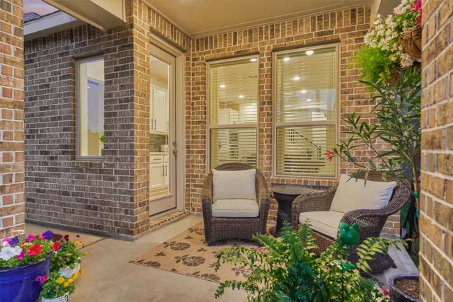 a balcony with furniture and a potted plant