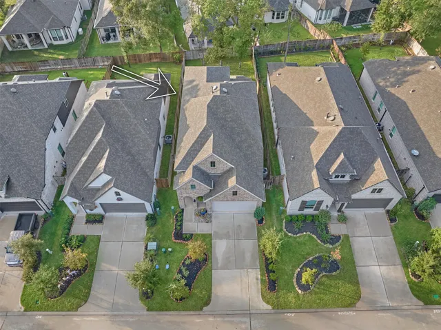 an aerial view of a house with a garden and trees