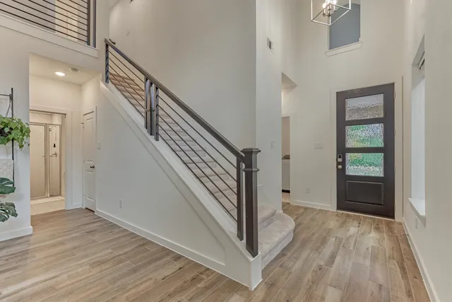 a view of a hallway view with wooden floor and staircase