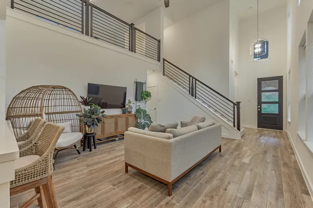 a living room with furniture a dining table and wooden floor