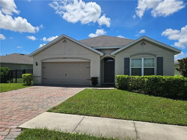 a front view of a house with a yard and garage