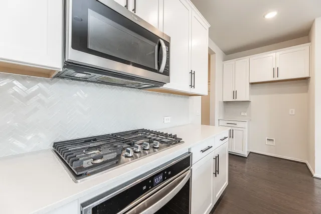 a stove top oven sitting inside of a kitchen