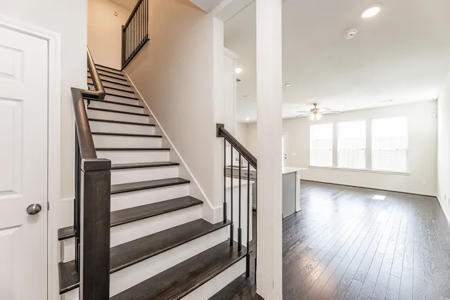 a view of an entryway with wooden floor and stairs