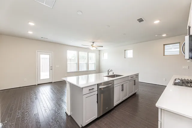 a kitchen with hard wood floors and a sink
