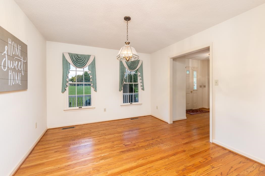 1275 Ladd Road Waynesboro, VA 22980 - Photo 29 of 75 a view of a room with wooden floor chandeliers and kitchen view