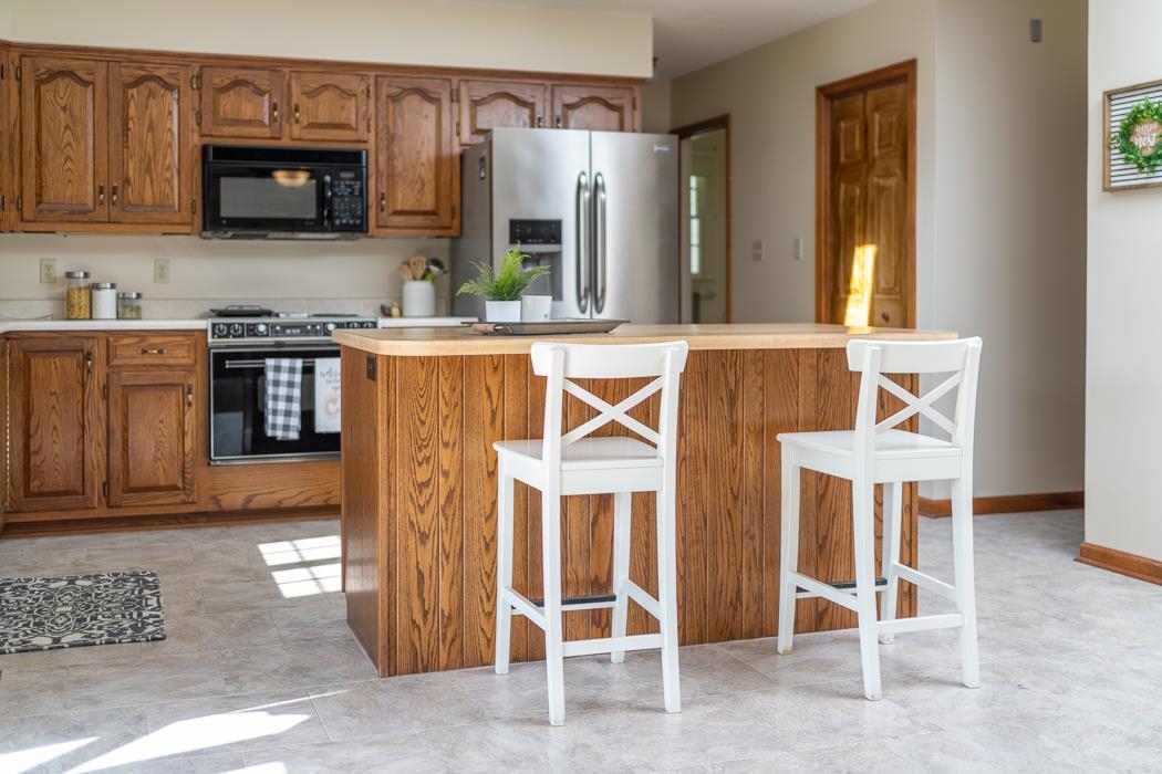 1275 Ladd Road Waynesboro, VA 22980 - Photo 36 of 75 a kitchen that has a stove and a wooden cabinets