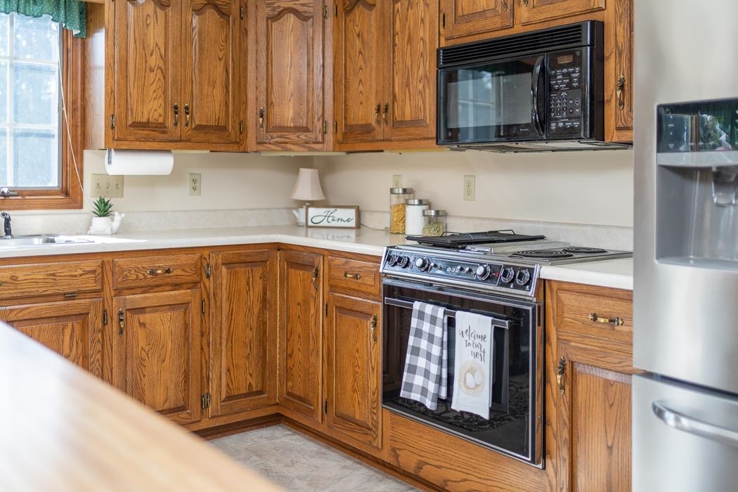 1275 Ladd Road Waynesboro, VA 22980 - Photo 37 of 75 a kitchen with stainless steel appliances granite countertop a stove a sink and a microwave