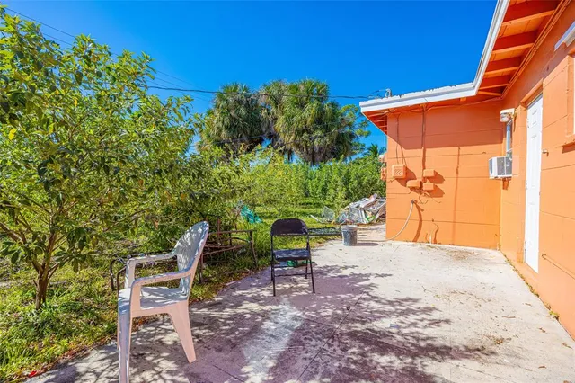 a view of a chairs and table in the backyard